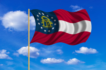 Flag of Georgia state waving on blue sky backdrop