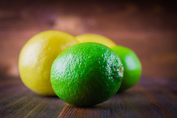 lemons and limes on a wooden background
