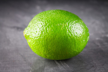 lemons and limes on a gray background