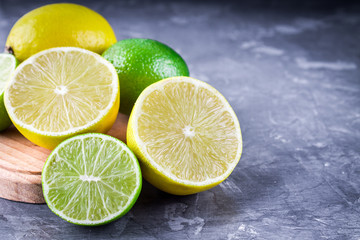 lemons and limes on a gray background