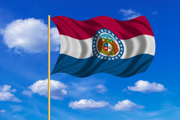 Flag of Missouri waving on blue sky background