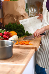 Young woman cutting vegetables in the kitchen