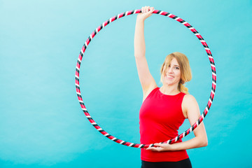 Fit woman with hula hoop doing exercise