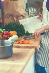 Young woman cutting vegetables in the kitchen