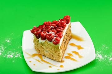 Delicious Raspberry Cake on white plate and green background