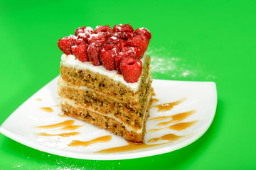 Delicious Raspberry Cake on white plate and green background