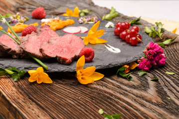 slices of duck fried meat in fancy food arrangement