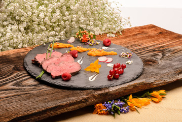 slices of roasted duck breast and garnish