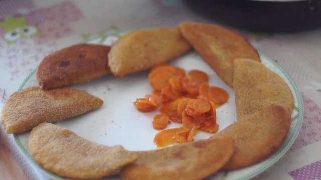 Video chef composes plate of breaded products with carrots
