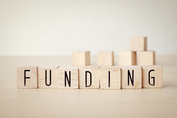Funding word on wooden cubes background