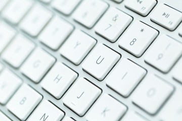 Close up of white wireless aluminum keyboard