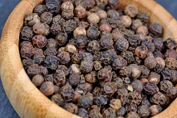 Bamboo bowl with black pepper