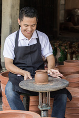 male potter making pot