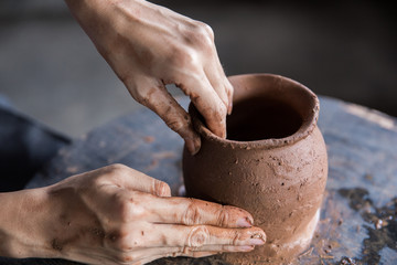 pottery making. hand transforming clay close up