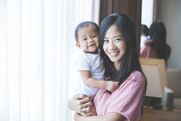 happy mother holding her baby