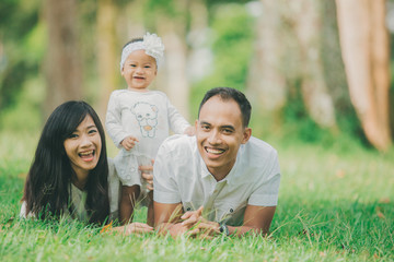 Happy family lying in the grass