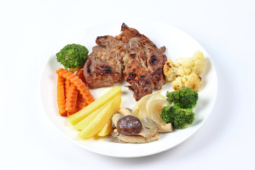 Home made ,Pork steak and mixed vegetables served.