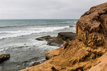 Cliffside erosion and ocean at the Point Loma tidepools in San Diego, California.
