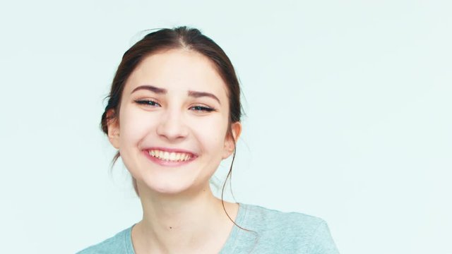 Portrait girl 14 years old teenager on the white background. Teen laughing at camera
