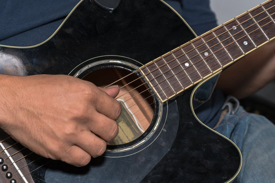 Man playing guitar , close up
