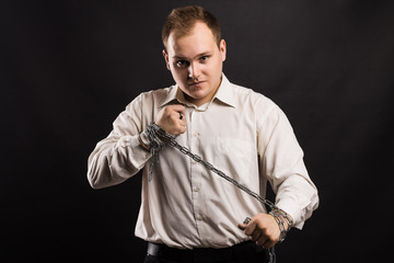 man in white shirt pulling  chain between hands