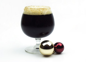 Christmas Ale sitting among bulb ornaments