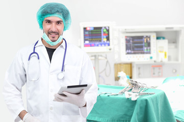 Young doctor using tablet computer in operating room