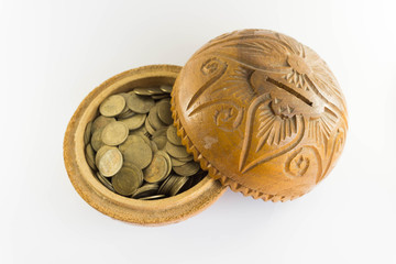 Old bowl filled with Thai baht coin on white background.