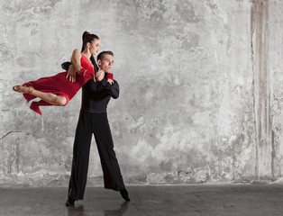 Beautiful couple in the active ballroom dance on wall