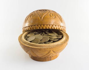 Old bowl filled with Thai baht coin on white background.