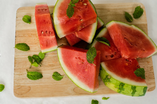 The water-melon cut on pieces, the fresh water-melon strewed listiky mints, healthy nutrition