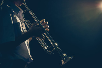 Young student Musician playing the Trumpet with spot light and l
