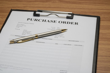 Close up of purchase order form with pen  / selective focus