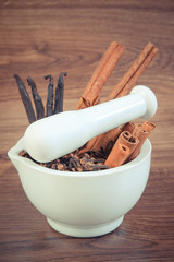 Vintage photo, Fragrant anise, cloves, cinnamon and vanilla sticks in mortar