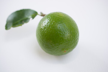 .Keep fresh lemon sour vitamin C from fresh green on a white bac