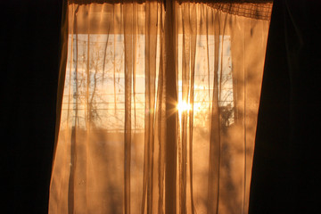 Sun shining through curtain.