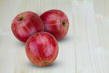 Fresh red apples on wooden background