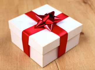 New Year gift on a golden tinsel background boly