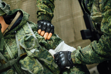 The soldier bandaging his friend in a combat situation.