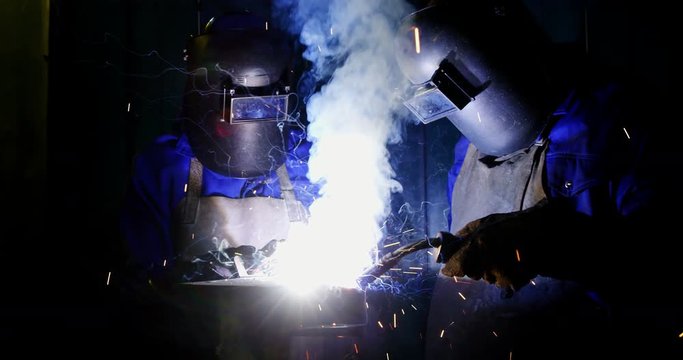 Welders welding a metal
