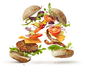 burger with flying ingredients - obrazy, fototapety, plakaty
