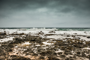 stormy sea with foamy waves and gray sky on Lanzarote