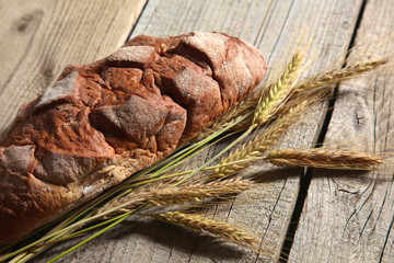 Freshly baked traditional bread on wooden table
