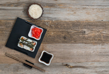 rolls on tray and a bowl of rice top view