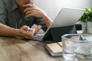 success businessman hand using stylus pen,digital tablet docking