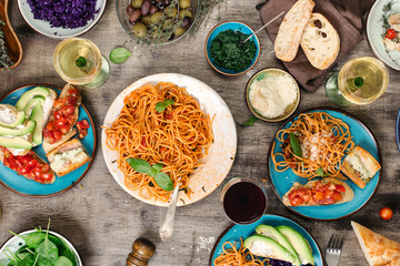 Italian pasta with tomato sauce with snacks and wine