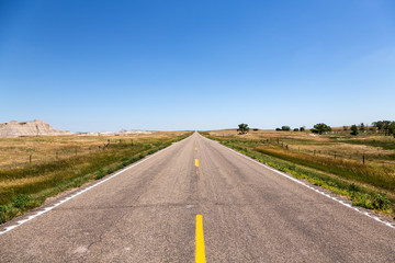 A road cutting through northern Nebraska on a summer day.
