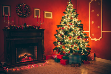 Beautiful Christmas living room with decorated Christmas tree, gifts and fireplace with the glowing...