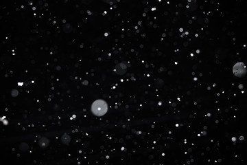 Falling snow on black background.