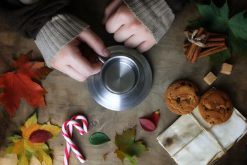 hands holding a mug of hot coffee on a table